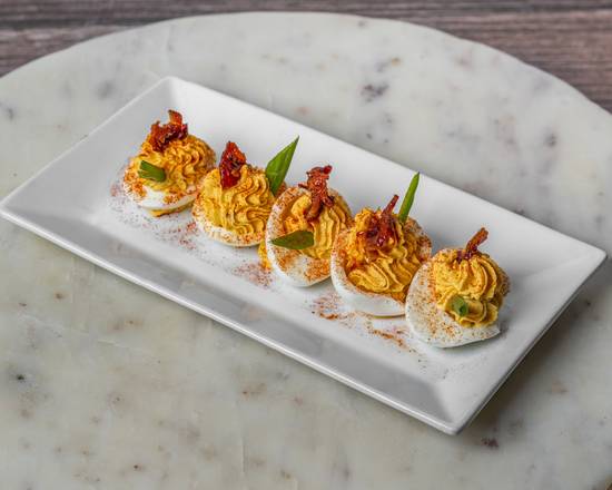 The District SPR signature dishes Maple Bacon Deviled EggsCrab CakeBeef Wellington